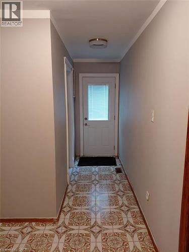 Hallway with patterned ceramic tile flooring - 244 Guildwood Drive, Hamilton, ON 