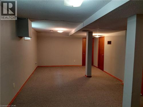 Finished room featuring textured ceiling, carpet flooring, recessed lighting, and multiple wood-panel doors - 244 Guildwood Drive, Hamilton, ON 