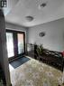 Patterned tile flooring, double entry doors with decorative glass panels, and a flush mount ceiling light fixture - 244 Guildwood Drive, Hamilton, ON 
