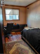 Wood-finish flooring, single window, and decorative crown molding - 