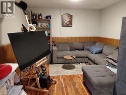 Wood-finish flooring with light-toned walls and wood paneling - 