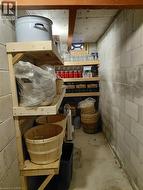 Concrete block walls with exposed wood structural beams and a concrete floor - 