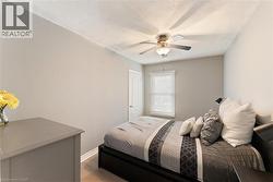 Interior room featuring neutral wall paint, a ceiling fan with light fixture, a window with blinds, and white trim - 
