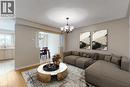 Open concept living area with wood-finish flooring, recessed lighting, and a chandelier - 21 Eastview Gate Unit# 36, Brampton, ON 