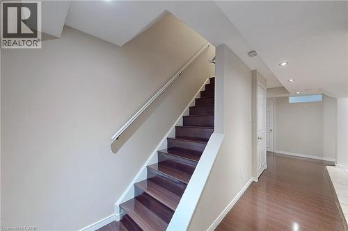 Staircase featuring wood-finish treads and risers, white handrail, recessed lighting, and wood-finish flooring - 21 Eastview Gate Unit# 36, Brampton, ON 