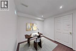 Recessed ceiling lighting, a narrow high-set window, and wood-finish flooring - 