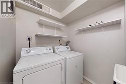 Dedicated laundry area with wall-mounted shelving and utility sink - 