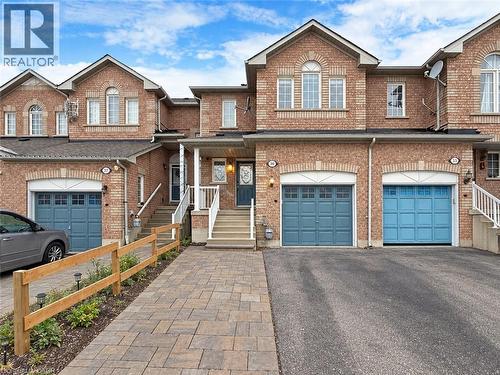 Brick exterior with arched window accents, individual garage, covered front entry, and paver stone walkway - 21 Eastview Gate Unit# 36, Brampton, ON 