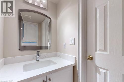 White vanity with a rectangular undermount sink, chrome faucet, and integrated lighting - 21 Eastview Gate Unit# 36, Brampton, ON 