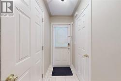 Tiled flooring, white paneled doors, and ceiling-mounted lighting fixture - 