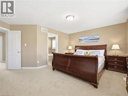 Carpeted bedroom with neutral wall tones and a white ceiling - 