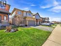 Two-story residence featuring a mixed-material facade with brick and siding, an attached single-car garage, and a paved driveway - 98 Willow Lane, Grimsby, ON 