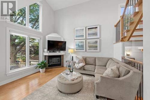 Floor to ceiling windows & built in gas fireplace. - 155 Nora Street, Ottawa, ON 
