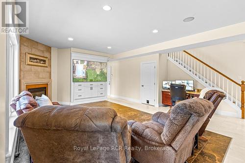 Living room with limestone fireplace - 758335 Girl Guide Road, Georgian Bluffs, ON 