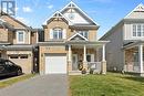 Front exterior with brick façade and garage - 223 Serra Ridge, Ottawa, ON 