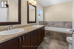 Primary ensuite with double vanity and soaker tub - 