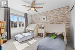 Third bedroom with feature wall and play space - 