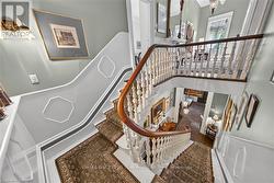 Ornate curved staircase featuring a wood handrail - 