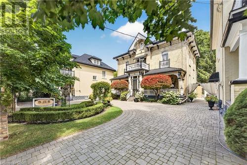 Brick exterior with arched windows & covered porch - 100 Brunswick Street, Stratford, ON 