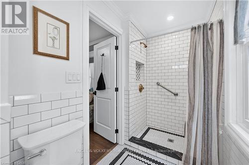 Subway tile shower with brass-finish fixtures - 100 Brunswick Street, Stratford, ON 