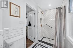 Subway tile shower with brass-finish fixtures - 