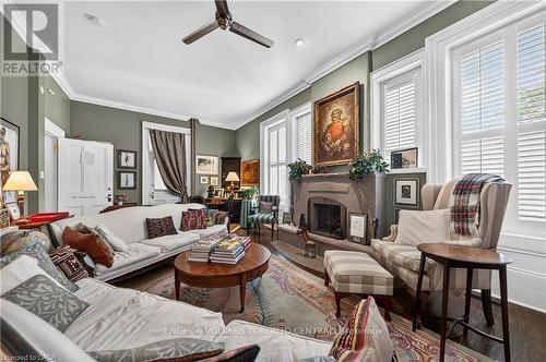 Living area featuring a stone-clad fireplace - 100 Brunswick Street, Stratford, ON 