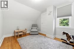 Hardwood flooring, window with cellular shade, recessed lighting, and white trim - 