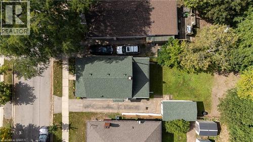 Gable roof residence featuring a front yard, a side driveway, and a rear yard with green space - 87 Strathcona Avenue, Brantford, ON 