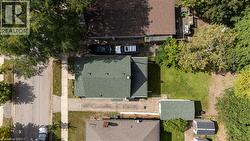 Gable roof residence featuring a front yard, a side driveway, and a rear yard with green space - 