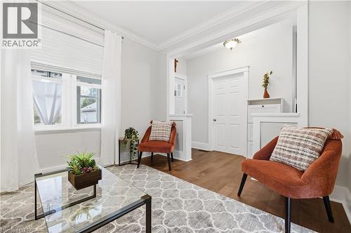 Wood-finish flooring, white trim, and crown molding accent the interior space - 87 Strathcona Avenue, Brantford, ON 