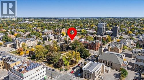 Urban landscape with various architectural styles, mature trees, and street infrastructure - 97 Wellington Street, Brantford, ON 