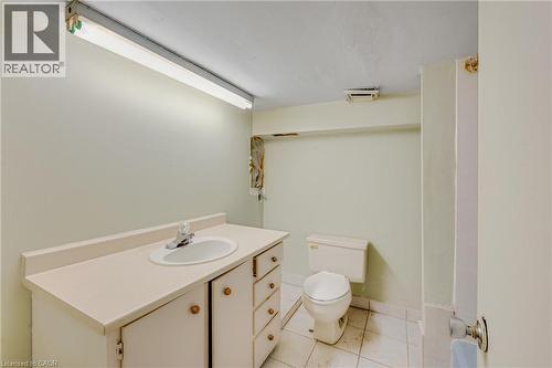 White vanity with an integrated sink and chrome faucet - 211 Wentworth Street N, Hamilton, ON 
