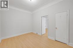 Light wood-finish flooring with white baseboards - 