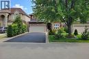 Brick facade with a double-car garage and asphalt driveway - 214 Cloverleaf Drive, Ancaster, ON 