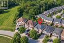 Brick facade residence with a gabled roof, attached garage, and paved driveway - 214 Cloverleaf Drive, Ancaster, ON 