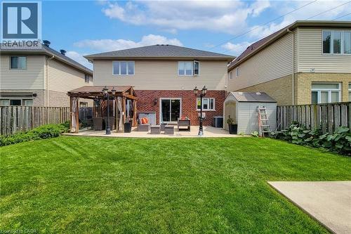 Expansive green lawn, paver patio, wood pergola, and a storage shed - 214 Cloverleaf Drive, Ancaster, ON 