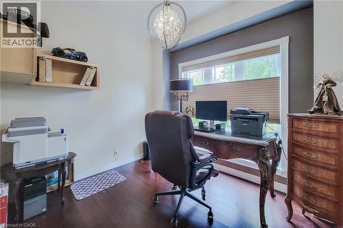 Hardwood-finish flooring, recessed lighting, double window with blinds, and built-in wall shelving - 214 Cloverleaf Drive, Ancaster, ON 