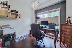 Hardwood-finish flooring, recessed lighting, double window with blinds, and built-in wall shelving - 