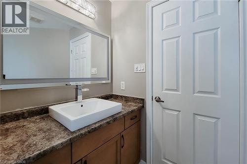 Vanity with a rectangular vessel sink, chrome faucet, and integrated lighting - 214 Cloverleaf Drive, Ancaster, ON 