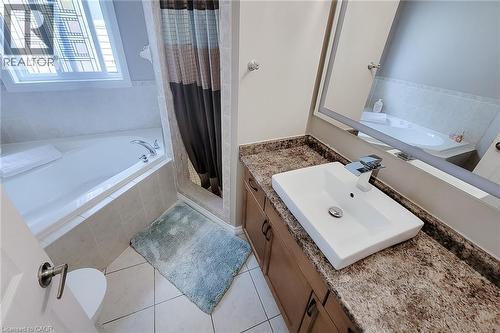 Rectangular vessel sink with a single-handle chrome faucet, set on a speckled countertop - 214 Cloverleaf Drive, Ancaster, ON 