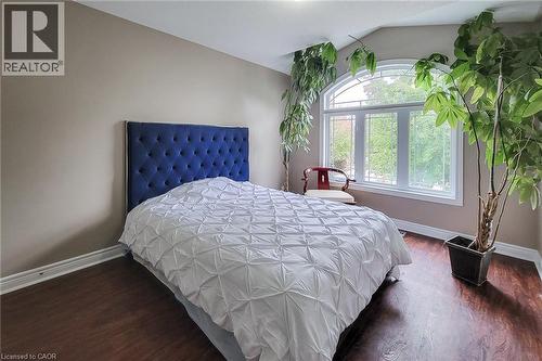 Arch-top window, wood-finish flooring, neutral wall color - 214 Cloverleaf Drive, Ancaster, ON 