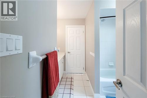 White paneled interior doors, tiled flooring, and a shower with white subway tile surround - 214 Cloverleaf Drive, Ancaster, ON 