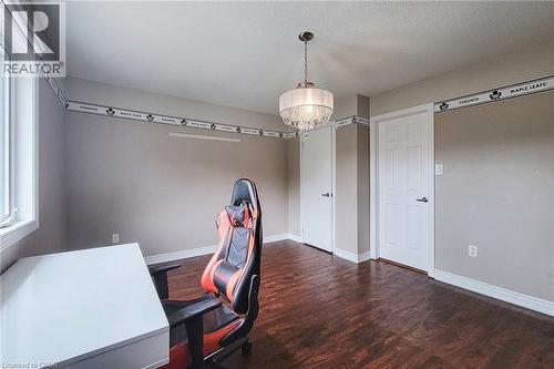 Hardwood-style flooring, white trim, recessed lighting, and a crystal chandelier - 214 Cloverleaf Drive, Ancaster, ON 