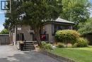 Brick exterior with a gabled roof and dark shingle roofing - 154 Ewen Road, Hamilton, ON 