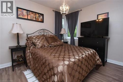 Recessed window, wood-finish flooring, and a decorative chandelier - 154 Ewen Road, Hamilton, ON 
