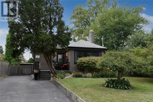 Brick exterior with a gabled roof and prominent chimney - 154 Ewen Road, Hamilton, ON 
