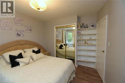 Recessed lighting, wood-finish flooring, mirrored closet doors, built-in shelving, and light-colored walls - 154 Ewen Road, Hamilton, ON 