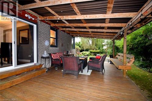 Expansive wood deck with a full-length covered pergola and exposed wood beams - 154 Ewen Road, Hamilton, ON 