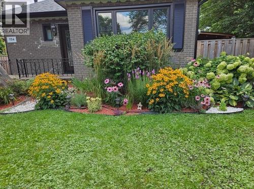 Brick exterior with dark trim windows - 154 Ewen Road, Hamilton, ON 