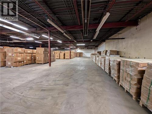 Concrete flooring with exposed ceiling beams and fluorescent lighting - 97 Ardelt Avenue, Kitchener, ON 